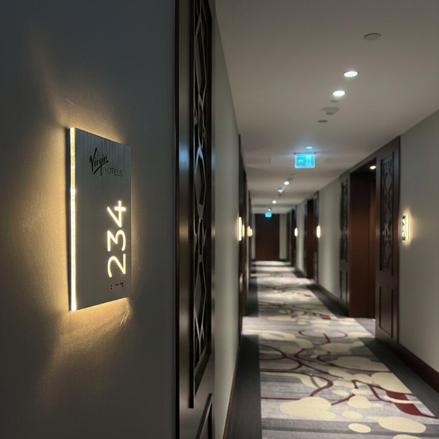 Hotel door number plaque with ADA compliant Braille and brand logo